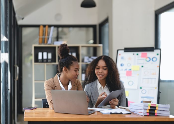 two-young-business-people-working-together-in-office-financial-analysis-accounting-concept-.jpg